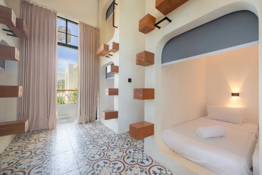Pod dorm with patterned tiles and tall windows