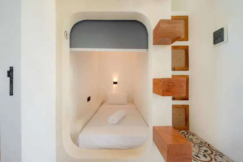 Single sleeping pod with reading light and fresh towel